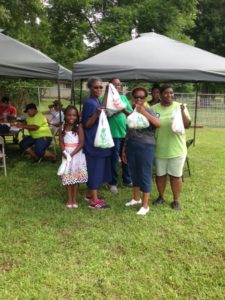 Local gardeners take home products from the day's harvest.