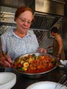 Woman holding up nutritious food in Alexandria.
