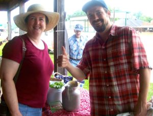 Two people smiling at Deans Farmers Market.
