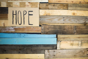 Hope sign against wood background.