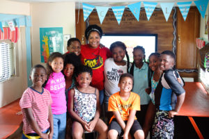 BCBS Foundation Angel Award nominee posing with group of children at school.