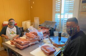 Two volunteers with Diva Dawgs Mass Feeding.
