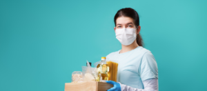 Woman carrying grain products with mask on.