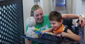 woman playing with disabled child
